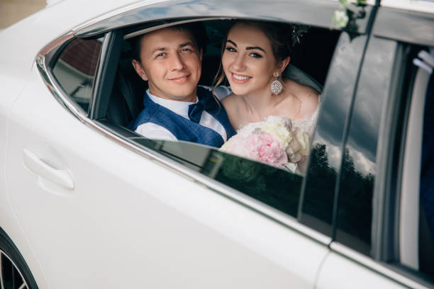 This image shows about a couple in their wedding in Classy Limo's car